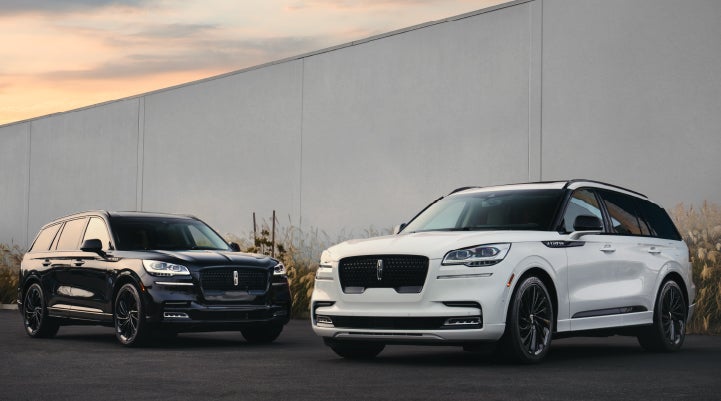 Two Lincoln Aviator® SUVs are shown with the available Jet Appearance Package | Dave Sinclair Lincoln in St Louis MO