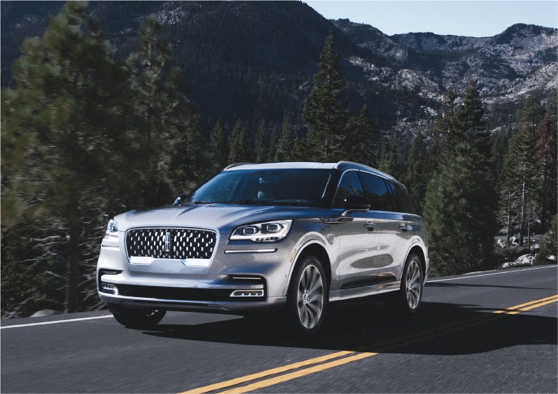 A 2023 Lincoln Aviator® Grand Touring SUV being driven on a winding road to demonstrate the capabilities of all-wheel drive | Dave Sinclair Lincoln in St Louis MO